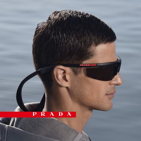 The new Prada Linea Rossa eyewear collection embodies the spirit of the 37th America's Cup competition with aerodynamic wraparound and ultra-light sporty frames inspired by the new AC75 Luna Rossa boat. Re Edition Prada, America's Cup, Drip Outfit Men, Americas Cup, Prada Eyewear, Luggage Bags Travel, Surf Life, Denim T Shirt, Winona Ryder