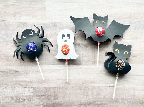 "Say \"Happy Halloween\" with this treat!  These lollipop holders fit a standard size lollipop and are so cute for classroom treats or to hand out to coworkers and trick-or-treaters!  These are available in 4 different shapes or a variety set - you choose! Some assembly required.  Lollipops are NOT included. Each lollipop holder is made from construction paper and includes double-sided tape.  Simple slide your lollipop into the hole, peel the tape, close it up and stick it shut. So easy and cute Halloween Lollipop Crafts, Halloween Lollipop Holders, Lollipop Halloween Treats, Cricut Halloween Lollipop Holder, Halloween Sucker Holder Svg, Halloween Cricut Candy Holder, Craft Holder, Halloween Lollipop, Halloween Food Crafts