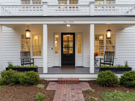 Create a warm space that welcomes the neighbors and guests alike with these front porch ideas. Colonial Front Porch Ideas, Cow Welcome Sign, Colonial Porch, Home Decor Front Porch, Bright Front Doors, Front Porch Welcome Sign, Colonial Revival House, Farmhouse Welcome Sign, Craftsman Style Doors