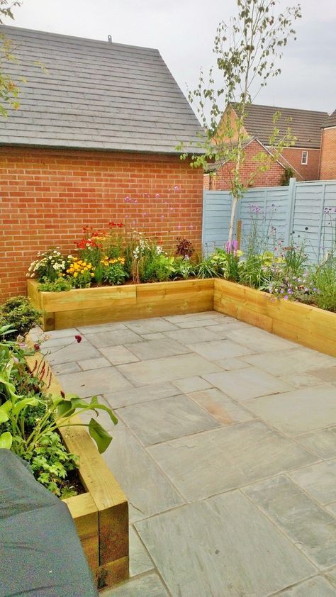 Grey Indian Sandstone in contemporary setting #Paving #Naturalmaterials Slabbed Garden Ideas, Sleeper Raised Beds With Seating, Small Slabbed Patio Ideas, Sandstone Garden Bed, Indian Sandstone Patio With Sleepers, Indian Sand Stone Patio, Terrace Vegetable Garden Ideas Indian, Terrace Garden Ideas, Easy Landscaping