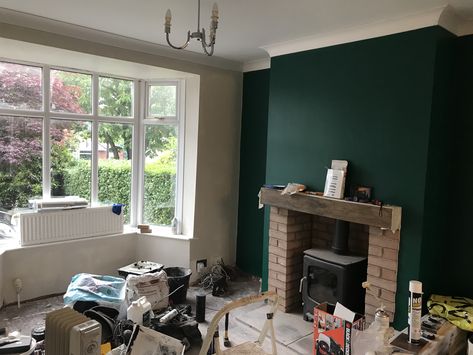 Dark green statement wall in living room with log burner Dark Statement Wall Living Room, Dark Green Statement Wall, Emerald Green Feature Wall Living Room, Green Chimney Breast, Green Chimney Breast Wall, Dark Green Feature Wall Living Room, Dark Green Feature Wall, Green Statement Wall, Statement Walls Living Room