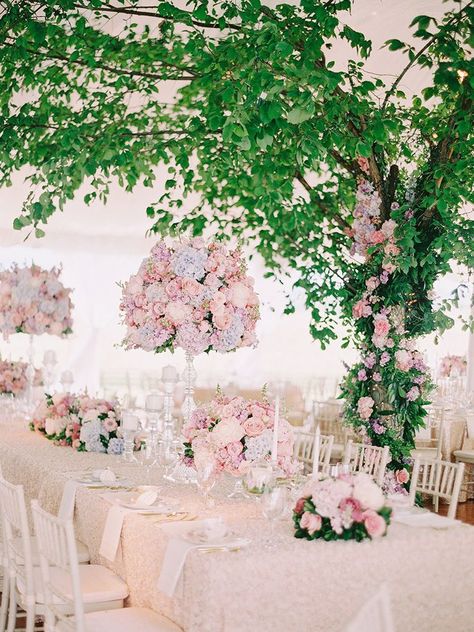 If you’re brainstorming romantic wedding ideas, think elaborate florals, a sweeping gown and elegant décor. As for your color scheme? Think pastels. Pink Rose Arrangements, Bohemian Wedding Centerpieces, Stage Wedding Decorations, Tree Wedding Centerpieces, Modern Wedding Centerpieces, Pastel Wedding Colors, Pink Wedding Centerpieces, Renew Vows, Greenery Centerpiece