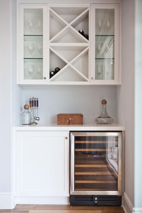 Dining Room decor ideas - a dry bar in your dining room allows you to keep all your bar items organized and is a great option for a small nook. Here, a wine refrigerator and cabinet create the base of the bar. Above, built-in shelving and glass-front cabinets provide wine bottle and glass storage. Refrigerator Ideas, Bar Nook, Built In Bar, Glass Front Cabinets, Home Bar Designs, Dry Bar, Wet Bars, Diy Wine Rack, Glass Storage