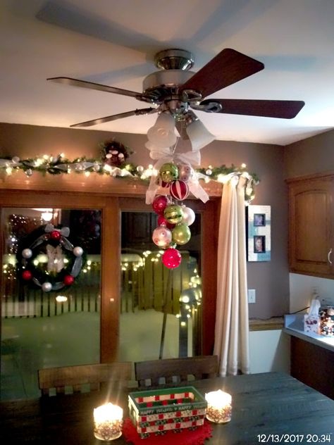 Kitchen ceiling fan decorated for Christmas Ceiling Fan Christmas Decorations, Ceiling Fan Christmas Decor Ideas, Christmas Ceiling Fan Decorations, Hanging Christmas Bulbs From Ceiling, Ceiling Fan Christmas Decor, Christmas Chandelier Decor, Decorative Ceiling Fans, Christmas Chandelier, Fan Decoration