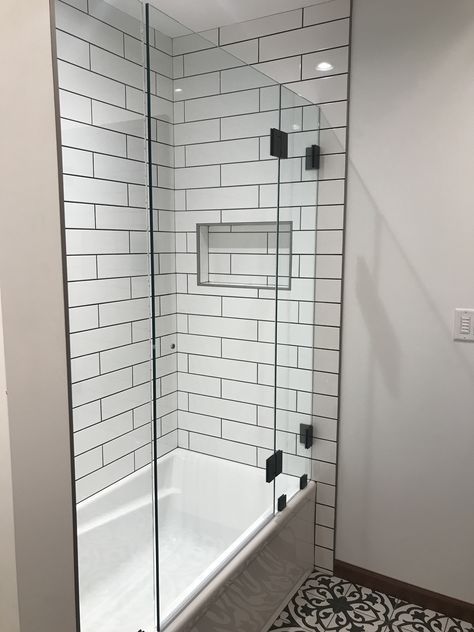 Shower Glass With Black Trim, White Subway Tile Shower Black Grout, Subway Tile Shower Black Floor, Subway Tile Tub Surround, Subway Tile With Black Grout, White Subway Tile Black Grout Bathtub, Tile With Black Grout, White Subway Tile Shower With Black Hexagon Floor, Freedom House