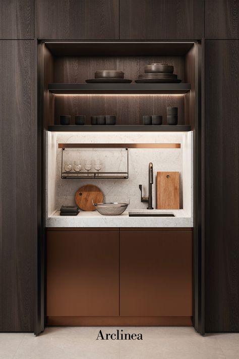 Small kitchen, the Arclinea New Pocket System door solution that creates an hidden mini-kitchen with brass kitchen doors and white marble worktop. Ideal kitchen solution for hotel rooms, small apartments and home living spaces with wooden walls. Pantry Living Room, Disappearing Pantry Doors, Kitchen Hidden Cabinets, Hidden Kitchen Office, Mini Pantry Cabinet, Hidden Pantry Cabinet, Concealed Kitchen Cabinets, Kitchenette In Living Room, Mini Pantry Design