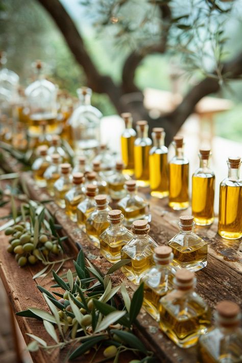 Capture the essence of love and harmony in your wedding details 🕊️✨ Snap your special day's favors amid luscious Italian olive branches, paired with charming miniature olive oil bottles. A symbol of the love's growth and peace to cherish forever. #WeddingInspiration #RusticWedding #OliveTheme #WeddingFavors #LoveAndPeace #ItalianWedding #BridalDetails #WeddingIdeas Italian Theme Wedding, Natural Wedding Theme, Olive Oil Wedding Favors, Italian Style Wedding, Italian Wedding Favors, Italian Theme, Olive Branches, Rustic Wedding Favors, Olive Oil Bottles