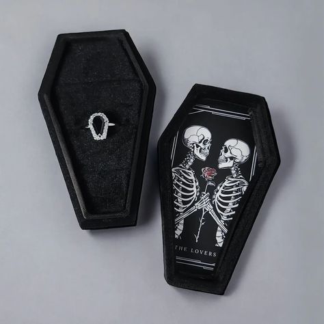 Custom coffin ring boxes now available 🖤 Whether to showcase your precious ring or to orchestrate a proposal of legendary proportions. Featured in black velvet, the interior offers three individual ring slots. All artwork done in our Melbourne studio. Different designs to select from. Add to your ring purchase or if we are currently making a ring for you let us know and we can add. Featured: The Lovers https://www.sapphirestudiosdesign.com/custom-coffin-ring-box Coffin Ring Box Wedding, Coffin Ring Box, Ring Boxes Engagement, Gothic Proposal, Ring Box Design, Making A Ring, Vampire Wedding, Black Ring Box, Coffin Ring