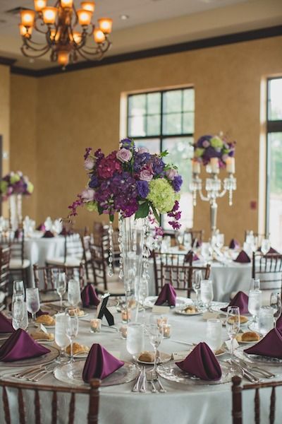 Tall Glass Centerpieces, Blue Floral Arrangements, Wedding Hall Decor, Elegant Wedding Centerpiece, Wedding Venue Decor, Purple Table, Military Wedding, Tall Centerpieces, Glass Centerpieces