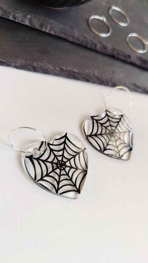 Heart shaped clear acrylic earrings with black cobweb design with hoops Heart Shaped Spider Web, Goth Resin, The Spooky One, Spooky One, Cute And Creepy, Clear Heart, Halloween Spider Web, Piercing Ideas, Handmade Heart