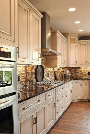 Gorgeous cream cabinets and chocolate counters with a perfactly complementing back splash. Dark Counters, Dark Countertops, Kabinet Dapur, Herringbone Backsplash, Pool Design, Stunning Kitchens, Kitchen Redo, White Kitchen Cabinets, Kitchen Remodel Idea