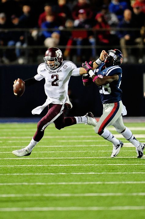 Johnny Manziel #2 of the Texas A&M Aggies stiff arms LaKedrick King #28 of the Ole Miss Rebels during a game at Vaught-Hemingway Stadium on October 6, 2012 in Oxford, Mississippi. Johnny Football, A&m Football, Aggie Football, Gig Em Aggies, Johnny Manziel, Heisman Trophy Winners, Heisman Trophy, Big Board, Texas A M University