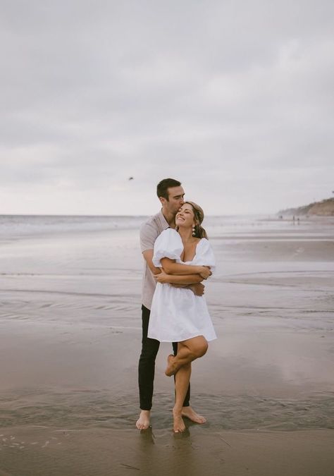 Cute Engagement Pictures Beach, Couple Beach Pictures Outfits Engagement Photos, Beach Dress Engagement Photos, Cloudy Beach Engagement Photos, Engagement Session Outfits Beach, Engagement Pictures By Water, Engagement Shoot Dress Beach, White Dress Beach Engagement Pictures, Engagement Pictures At The Beach