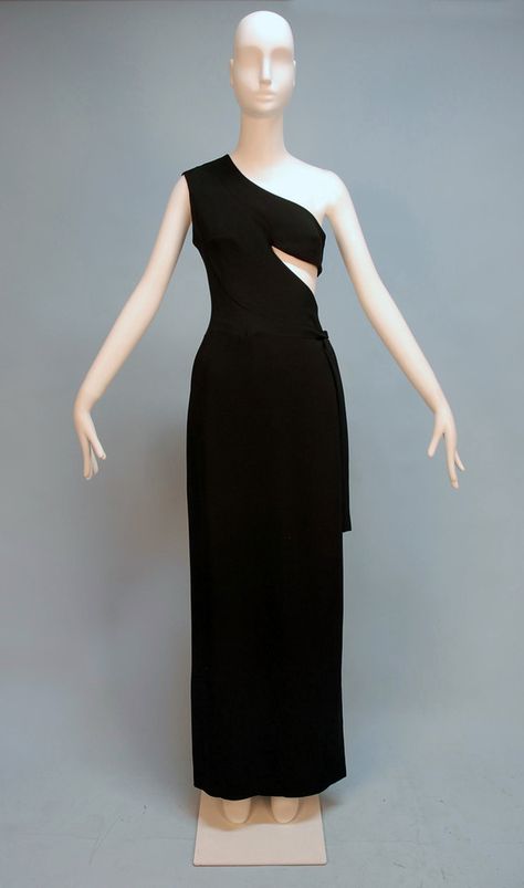 MADAME GRES ASYMMETRICAL ONE-SHOULDER GOWN, c. 1970. Black rayon faille wrap style with triangular side cutout, side self tie over hook and eye closures and snaps, Paris label. Front Madam Gres, 1970s Vintage Fashion, Grecian Gown, Madame Gres, 20th Century Fashion, French Fashion Designers, Couture Designers, Vintage Couture, 1970s Fashion