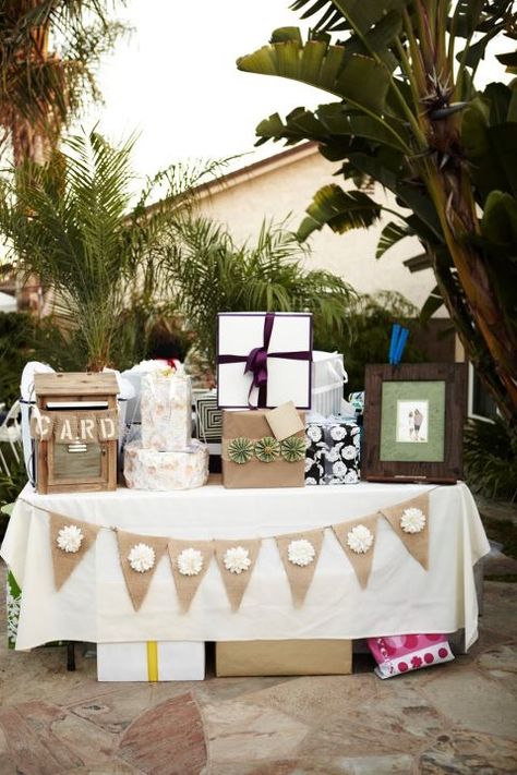 gift table with banner, pom poms hanging above and chalk board that says 'o you shouldn't have' Table With Gifts, Gift Table Decorations Birthday, Display Shower Gift Table Cute Ideas, Gift Table Ideas Graduation, Boho Gift Table Ideas, Gift Table Set Up, Party Gift Table Ideas, Presents Table Wedding, Gift Table Birthday Party