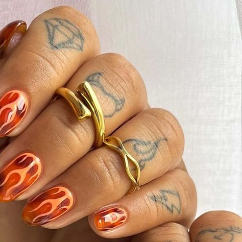 Jade Knight | Nail Artist on Instagram: "Tortie ft orange flames 🔥   Using all @dali.artistic because it’s the best in the game!  Use my code JADECREATIVE to save 😍😍😍   @bohomoon  use my code to save 💰 BYJAY10  #tortie #tortienailart #flames #flamenails #showscratch #nailitdaily #nailitmag #nailit #thesalonmaguk #orangenails #almondnails #nailsofinstagram #nailsdesign #nailinspiration #nailinspo #goldrings #bohomoon #bohomoonrings #fashion #style #stylish #nailstagram #love #obsession #" Nail Flames Design, Short Nails Flames, Short Nail Designs Orange, Acrylic Nail Designs Autumn, 60s Nail Art, Bright Fall Nails, 70s Nail Designs, Masc Nails, Squiggle Nails