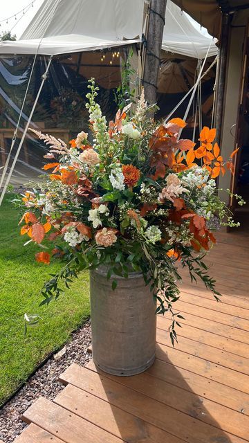 Milk churn filled with seasonal autumnal foliage's and peach and white flowers. These statement wedding designs are great for repurposing throughout your wedding day Milk Churn Wedding Flowers, Toffee Roses, Autumn Wedding Ideas, Milk Churn, Churning Butter, Barn Reception, Deep Orange, Barn Wedding Venue, Wedding Flower Arrangements