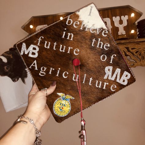 My high school graduation cap featuring the opening line to the FFA creed and my brand and my family’s brand.❤️ Ag Teacher Graduation Cap, Cowhide Graduation Cap, Agriculture Graduation Cap Ideas, Ag Graduation Cap, Agriculture Graduation Cap, Ffa Graduation Cap, 2026 Senior, Ffa Creed, Country Graduation