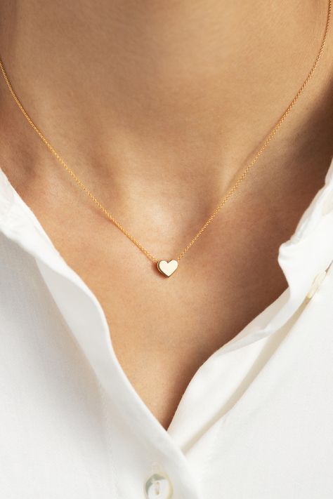 This petite gold heart pendant necklace will compliment everything from denim to little black dresses. Designed with both comfort and style in mind, this piece is perfect for everyday wear. Minimalist with a high shine finish, this small yet mighty stunner is bound to become a staple in any gal’s ensemble. Gift this symbolic piece to a loved one or better yet, gift it to yourself! Small Heart Necklace, Tiny Heart Necklace, Heart Choker Necklace, Aventurine Necklace, Double Heart Necklace, Heart Choker, Heart Pendant Gold, Diamond Cross Pendants, Gold Heart Necklace