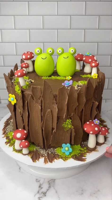 Yes…… yes I am 🐸❤️🐸 🐸 Obsessed with frog cakes 🐸 I made all the decorations with fondant (🐸🍄🌸) and I followed the lovely @sheri_wilson_ tutorial to make the tree bark. It’s so easy to follow and looks so real 💚 My kids asked for a “frogs on a log” cake and this is what I made them. Their little faces when they saw it…. priceless ❤️ #cakedecorating #enchantedforest #frogcake #cakeart #cakedesign #bakinginspo #cakedbyrach | Caked By Rach | Easy Frog Cake, Nature Cake Ideas, Frog Cake Ideas, Fondant Frog, Woodsy Cake, Frogs On A Log, Frog Birthday Cake, Sheri Wilson, Mushroom Birthday