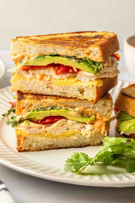 Inspired by Panera's sandwich of the same name, this chipotle chicken avocado melt recipe is a delicious and filling sandwich you can make at home. Toasted sourdough bread is layered with zesty chipotle mayo, creamy avocado slices, smoked chicken and vibrant peppadew peppers to create a dairy free panini that's full of bold flavor. Chipotle Chicken Avocado Melt, Onion Soup Mix Meatloaf, Chicken Avocado Melt, Chicken Avacado, Chicken Avocado Sandwich, Avocado Melt, Panera Recipes, Chipotle Recipes Chicken, Peppadew Peppers