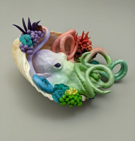 Handmade polymer sculpture.  This pastel octopus sits in a shell surrounded by corals and anemones.  While this sculpture has been baked and is relatively strong, it can break if handled roughly or dropped. Unique Sculptures Creative, Realistic Clay Animals, Sea Shell Sculpture, Polymer Clay Bead Ideas, Sculpey Clay Ideas Projects, Clay Projects For High School, Animal Sculptures Clay, Clay Sea Creatures, Cute Polymer Clay Ideas