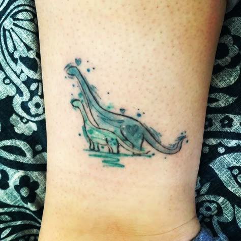 210+ Most Beautiful Dinosaur Tattoos For Men and Women (2022) - TattoosBoyGirl Dinosaur Collar Bone Tattoo, Good Dinosaur Tattoo, Mom And Son Dinosaur Tattoo, The Good Dinosaur Tattoo, Dainty Dinosaur Tattoo, The Mummy Tattoo Ideas, Baby Dino Tattoo, Baby Dinosaur Tattoo, Dinosaur Tattoo For Son