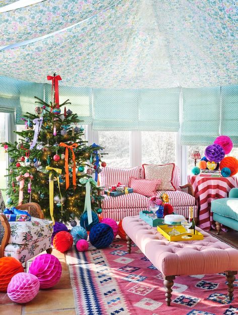 Sophie Robinson's conservatory at Christmas Fence Paint Colours, Maximalist Christmas, Patterned Sofa, Christmas Interior Design, Sophie Robinson, Rainbow Wreath, Paper Balls, Christmas Interiors, Blue Candles