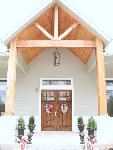 Front porch with exposed timbers. Front porch with exposed timbers and columns. Front porch with exposed timbers, timber columns, vaulted ceiling and double doors. # Frontporch #porch #exposedtimbers #timbercolumns #vaultedceiling #Doubledoors Exposed Beams Front Porch, Front Porch Exposed Beams, Gable Roof Porch Front Entry, Cordwood Path, Gabled Porch, Porch Goals, Farmhouse Front Porch Decor, Front Porch Addition, Porch Kits