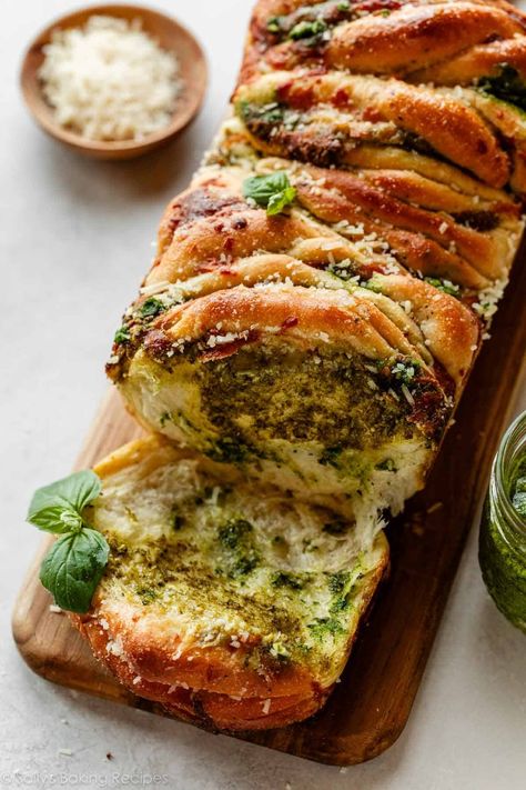 Buttery-soft and flaky, this pesto pull apart bread is brimming with fresh flavor. Stuff homemade herbed dough with mozzarella cheese and homemade pesto, then arrange it all in a loaf pan. When it's fresh out of the oven, add a dose of garlic butter and watch as the bread disappears piece by torn-apart piece. Recipe on sallysbakingaddiction.com Pesto Pull Apart Bread, Homemade Monkey Bread, Loaf Bread Recipe, Homemade Pesto Recipe, Pesto Bread, Bread Pull Apart Recipes, Pesto Cheese, Herb Bread, Sally's Baking