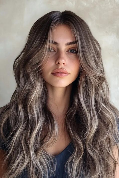 Woman with long, wavy brown hair and a neutral expression against a plain background. Brown Hair With Blonde Highlights Pale Skin, Dark Brown W Blonde Highlights, Brunette Hair Ash Highlights, Long Hair Highlights Brown, Brown With Ashy Blonde Highlights, Dark Brown Hair With Cool Blonde Highlights, Biscuit Brown Hair, Cute Natural Hair Color Ideas, Brown Ashy Highlights