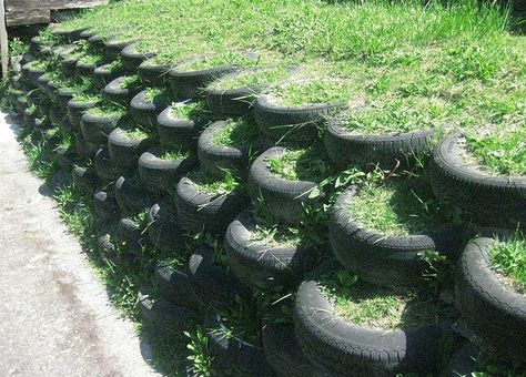 Tire retaining wall. All it needs is some plants and it would look super Tire Retaining Wall, Cheap Retaining Wall, Retaining Wall Construction, Gabion Retaining Wall, Casa Hobbit, Tire Garden, Tire Planters, Earthship Home, Landscaping Retaining Walls