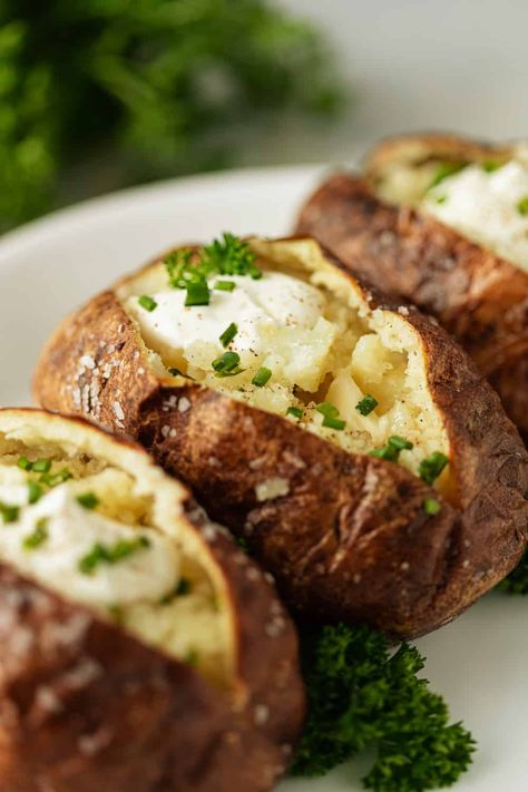 Learning how to make baked potatoes is a skill everyone can use. In this recipe, we make them with slightly crispy skin and the perfect fluffy interior! Make Baked Potatoes, Perfect Baked Potato, Making Baked Potatoes, Steak And Ale, Potatoes In Oven, Baked Falafel, Idaho Potatoes, Baked Potato Recipes, Baked Potatoes