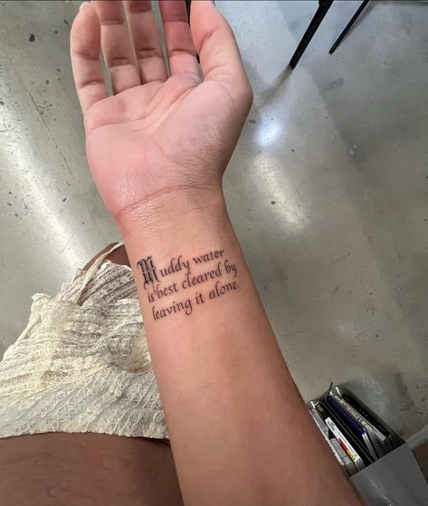 Doja Cat's Wrist Tattoo that reads "Muddy water is best cleared by leaving it alone." Mens Body Tattoos, Cat Tatto, Water Tattoo, Writing Tattoos, Classy Tattoos, Muddy Waters, Vedic Astrology, Little Tattoos, Piercing Tattoo