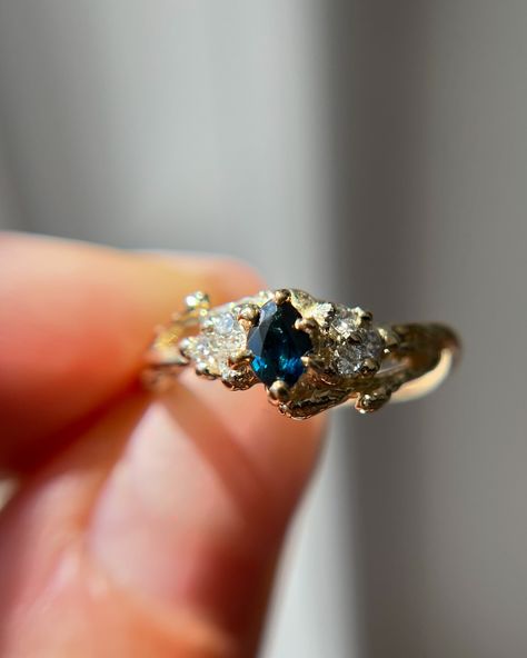 Have you met our new ONE-OF-A-KIND Feyre ring? She has the sweetest marquise cut teal blue sapphire and a cluster of natural diamonds ✨🌌 • • • • • #oliviaewing #oliviaewingjewelry #naturelovers #nature #naturejewelry #branchjewelry #forestjewelry #natureasthetic #cottagecore #cottagestyle #fairytale #fairyaesthetic #fairycore #acotar #feyre #fairylife #acotarjewelry #acourtofthornsandroses #acotafanart #fairytail #fairytale #lotr #lordoftherings #lordoftheringsjewelry #woodlandring #botani... Feyre Ring, Acotar Feyre, Fairytale Engagement Rings, Traditional Engagement Rings, Fairy Aesthetic, Montana Sapphire, Raw Gemstones, Nature Jewelry, Marquise Cut