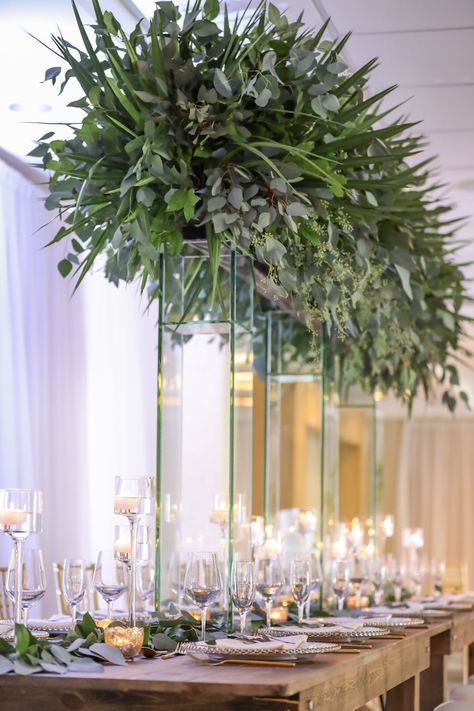 Hotel Ballroom Wedding Reception With Long Wood Feasting Table, Extra Tall Greenery Centerpiece in Clear Glass Rectangular Vases, Gold Chiavari Chairs, White Draping, and Glass Candleholders at Varying Heights and Gold Beaded Glass Chargers | Beach Hotel Wedding Venue Hilton Clearwater Beach Wedding Table White, Hotel Ballroom Wedding, Beach Centerpieces, Ballroom Wedding Reception, Clearwater Beach Wedding, Beachfront Wedding, Feasting Table, Long Table Wedding, Gold Chiavari Chairs