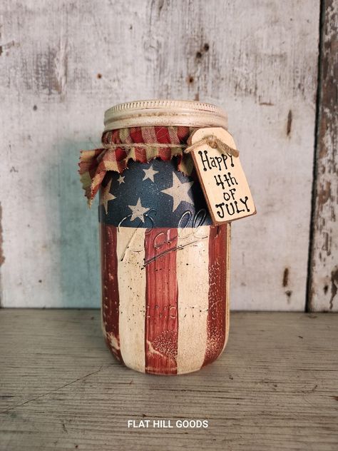 Size: 7" Tall x 3 1/2" Primitive Americana on Ball Mason Canning Jar JAR #2 Americana  Jar is Very Rustic / Primitive Hand Painted Canning Jar. Has crackle, sanded off paint, heavily antiqued, aged and flicked with black paint The jar has been sealed, finished with homespun top. and wood tag.  Current Tag reads: Happy 4th of July.  Choose your saying. Do not submerge the jars underwater or let them soak in the sink. For Decorative Use Only. Most items in my shop are pre loved and show wear. The majority of my pieces are painted on salvaged wood, barn board, pine and are in rustic condition. Finishes may differ as materials and wood take paint and mediums differently. No two items are alike as I do the finish painting, distressing and antiquing by hand. I will combine shipping and any amoun Primitive Jars Ideas, Painting Canning Jars, Primitive Mason Jars, Americana Kitchen, Rustic Americana, Primitive Americana, Ball Jar, Wood Barn, Wood Tags