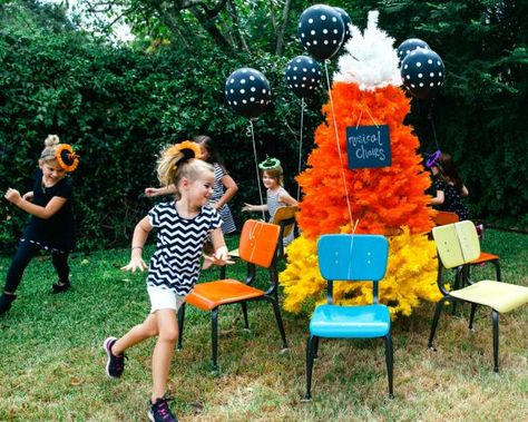 Halloween musical chairs is just like ordinary musical chairs, only played to a Halloween soundtrack and full of fun Halloween decor. As ordinary musical chairs goes, it is a blast for all ages and brings out just enough of everyone’s competitive spirit. Set up chairs around a fun tree decorated for Halloween, as designer Jennifer Perkins did here. Forest Ideas, Party Stations, Fun Halloween Party Games, Halloween Christmas Tree, Halloween Party Decor Diy, Fun Halloween Games, Musical Chairs, Easy Halloween Party, Haunted Forest