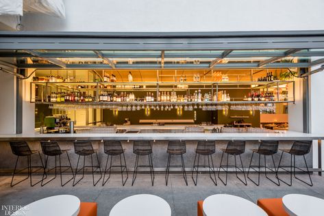 Audrey at the Hammer’s nearly 30-foot, double-sided bar sits between the dining room and the courtyard. Indoor Outdoor Restaurant, Gubi Beetle Chair, Indoor Outdoor Bar, Precast Concrete Panels, Beetle Chair, Precast Concrete, Outdoor Restaurant, Outdoor Bar, Color Tile