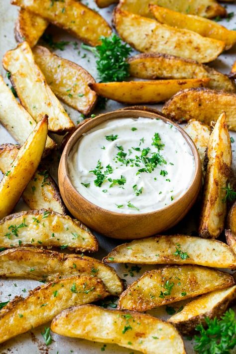 A sheet pan of baked potato wedges with a container of ranch dip. Potato Wedges Fried, Slow Cooker Chicken Marsala, Wedge Fries, Baked Potato Wedges, Crispy Potato Wedges, Oven Baked Fries, Crispy Baked Potatoes, Potato Wedges Recipe, Potato Wedges Baked