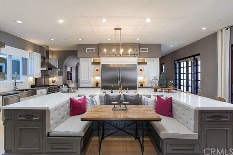 Jim Edmonds and Meghan King Edmonds Sell Their Orange County Home | realtor.com® Grand Kitchen Design, Banquette Island, Kitchen Island With Booth Seating, Grand Kitchen Luxury, Kitchen Island Booth, Mansion Kitchen, Kitchen Dining Room Combo, Open Plan Kitchen Dining Living, Large Open Plan Kitchens