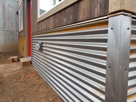 Rusting Corrugated Metal run Horizontally. Little features like drip edge under the siding and covered corners and outlets give the nice clean look. Corrugated Metal Siding Exterior, Corrugated Metal Underpinning, Corrugated Metal Skirting, Metal Deck Skirting Ideas, Under House Skirting, Corrugated Metal Deck Skirting, Tin Underpinning, Tin Underpinning Mobile Home, Corrugated Metal Siding House