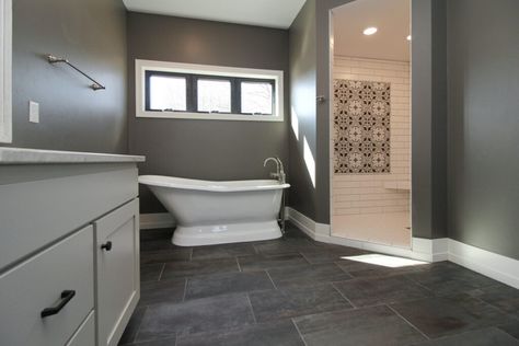 White subway tile shower with patterned accent in dark bathroom with white tub and black tile flooring. Dark Master Bath, Black Tile Flooring, Tiled Showers, White Subway Tile Shower, Dark Bathroom, Subway Tile Showers, Black Floor Tiles, Bathroom Showers, Pony Wall