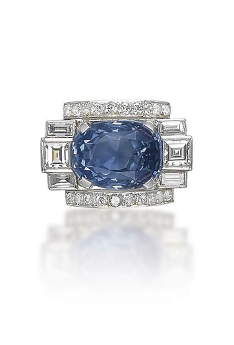 AN ART DECO SAPPHIRE AND DIAMOND RING The cushion-shaped sapphire flanked with square and baguette-cut diamonds, to the brilliant-cut diamond line detail, mounted in platinum, 1930s Art Deco Diamond Sapphire Ring, Diamond Sapphire Ring, Bijoux Art Deco, Art Deco Jewellery, Diamond Cocktail Ring, Sapphire And Diamond Ring, Jewelry Auction, John Hardy, Art Deco Diamond