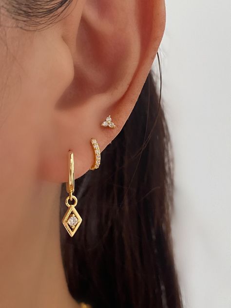 Minimalist Sterling Silver with 18k gold plated Huggie Dangly Stud Earrings set. Perfect for a gift for your loved ones or for yourself. Come in 2 different Sets.A+B+C SET with a gift boxA+C SETA. Gold Dangle Earrings. 18k gold plated on brass, 925 sterling silver post.-measurements: length-23 mm, hoop inner diameter- 9.5 mmB. Gold huggie hoop 7mm. 925 Sterling Silver with 18k gold plated.-measurements: Hoop outer diameter: 9.7mm , Hoop inner diameter: 7mmC. Gold Stud Earrings. 925 sterling silv Multiple Dangling Earrings, Ear 3 Piercings, Gold Earrings Piercings, Earrings For Graduation, 3 Pericing Ideas, 3 Peircings Earring Gold, Gold Accessories Earrings, Gold Earrings Ideas, Earings Piercings Gold