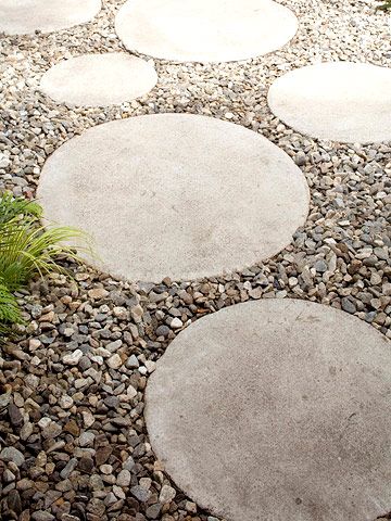 Concrete steppers laid in gravel create a cute pathway that connects the outdoor room to the back of the house. By covering the yard with gravel, the homeowner has very little yard maintenance to deal with, giving him more time to enjoy the fruits of his labor. Colored Cement, Inspiring Gardens, River Pebbles, Green Gardens, Yard Maintenance, Gravel Path, Outdoor Room, Garden Pathway, Paving Stones