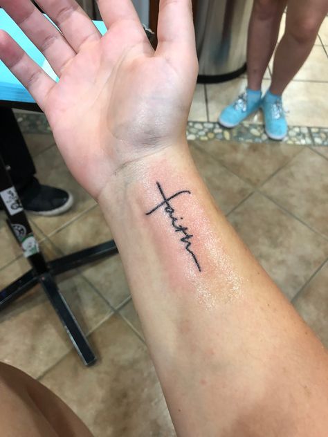 Faith Forearm Tattoo For Men, Cross On Arm Tattoo Women, The Word Faith Tattoo, Faith Wrist Tattoos For Women, America Tattoo For Women, Cross Tattoos For Women On Wrist, Simple Girly Tattoos, Faith Tattoo Ideas For Women, Cross Wrist Tattoo