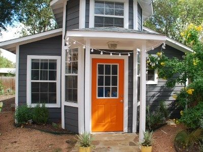 Dark Grey Houses, Orange Front Doors, Austin Vacation, Gray House Exterior, White Shutters, Orange Door, Gray House, Grey House, Bungalow Exterior