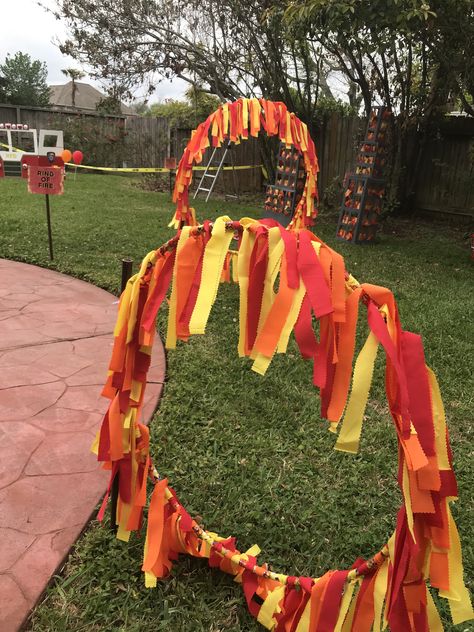 This is the ring of Fire game made from hula hoops and broadcloth. It is held up with pvc pipe and zip ties. Circus Theme Float, Diy Ring Of Fire Hula Hoop, Circus Theme Decorations Diy, Ring Of Fire Hula Hoop, Diy Circus Props, Carnival Party Decorations Diy, Circus Vbs Decorations, Carnival Arts And Crafts, Circus Games For Kids