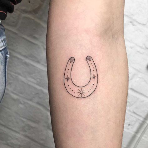 Minimal horseshoe tattoo inked on the left forearm Tiny Horseshoe Tattoo Simple, Mini Horseshoe Tattoo, Horseshoe Tattoo, 22 Tattoo, Horse Shoe Tattoo, Cage Tattoos, Shoe Tattoos, Country Tattoos, Belly Tattoos